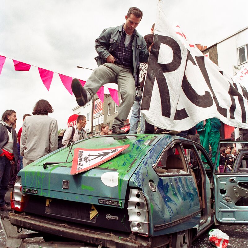 A man standing on top of a car