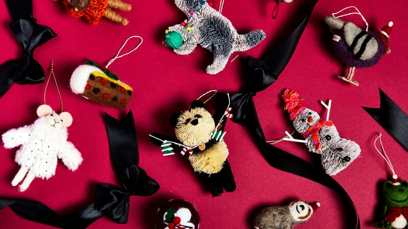 A flat lay of Christmas baubles and decorations with some black bows