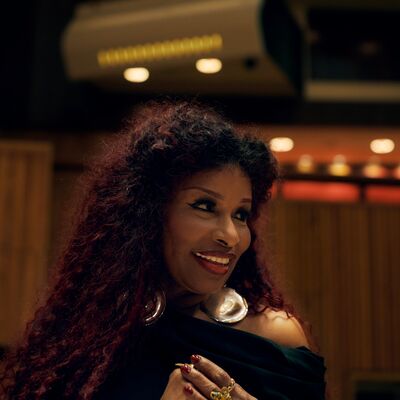 Chaka Khan is smiling and looking to her left.