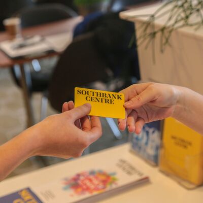 Hands exchanging a membership card