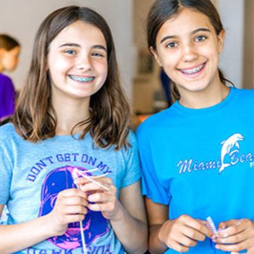 Two young girls smiling 