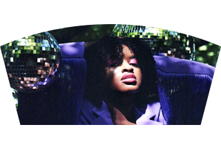 Singer Aisha Kigs surrounded by disco balls and plants 