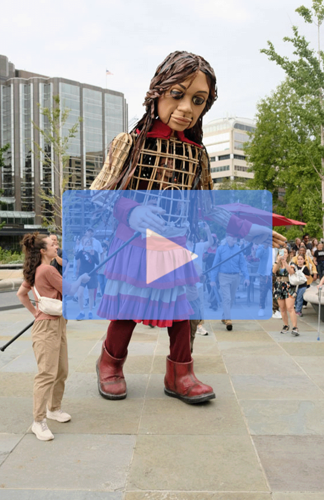 A video thumbnail featuring Little Amal. Links to Facebook. 