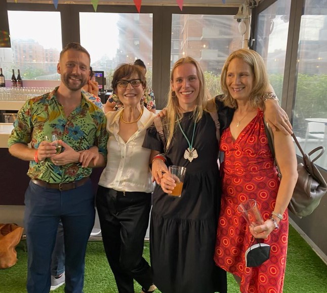 A photo of Ron Carlos (Faculty), Beth McGuire (Former Faculty), Jane Guyer Fujita (Former Faculty), and Grace Zandarski (Faculty) at Beth's retirement party.