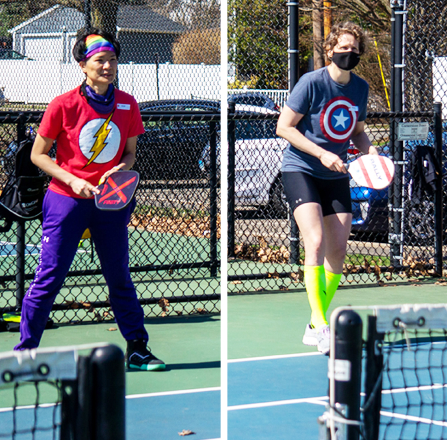 two active humans playing pickleball in superhero tee shirts