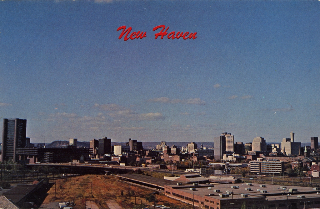 Postcard of New Haven's skyline with a red cursive font in the sky reading "New Haven"