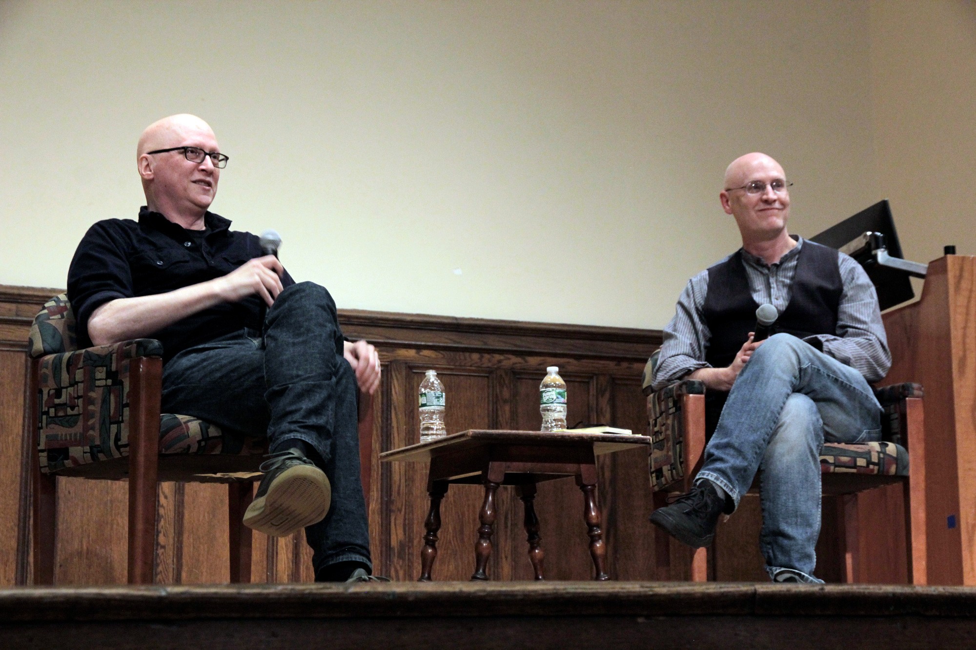 photo of two bald white men on a stage